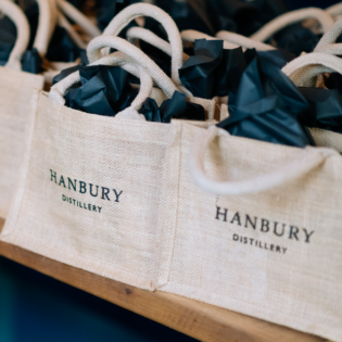 A close-up photo of the Hanbury Gin Mini Jute Bag, showcasing its stylish design and eco-friendly materials.