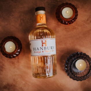 Flatlay of Hanbury Orange & Thyme Gin bottle