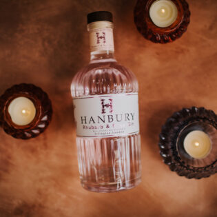 Flatlay of Hanbury Rhubarb and Rose Gin bottle