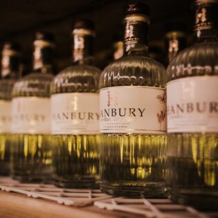 Row of Hanbury London Dry Gin bottles at The Distillery in Islington, London.