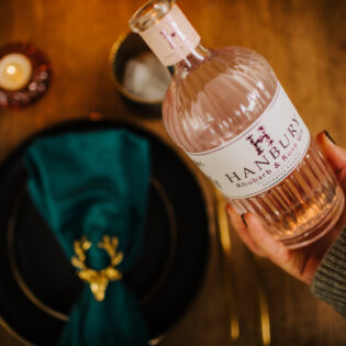 Pouring a glass of Hanbury Rhubarb and Rose Gin.