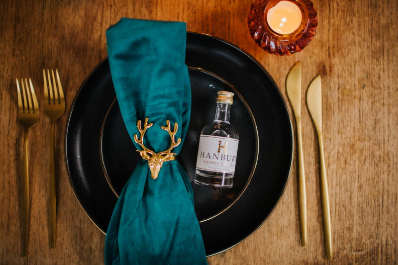 Miniature bottle of Hanbury London Dry Gin on a stylish table setting"